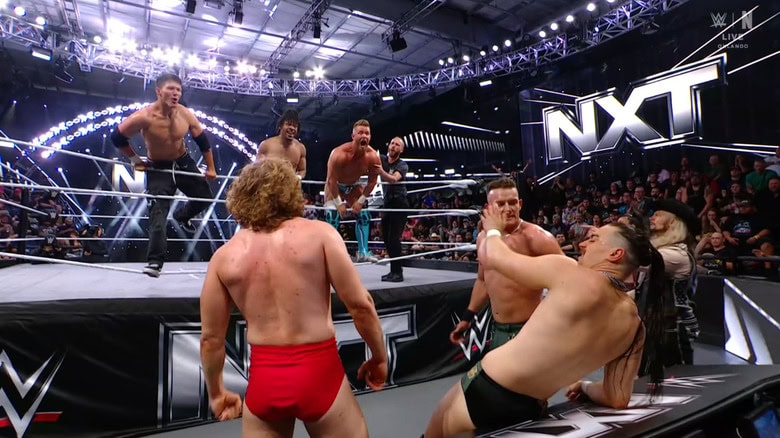 All six men on the outside of the ring