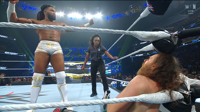 Williams standing over Zayn in the corner