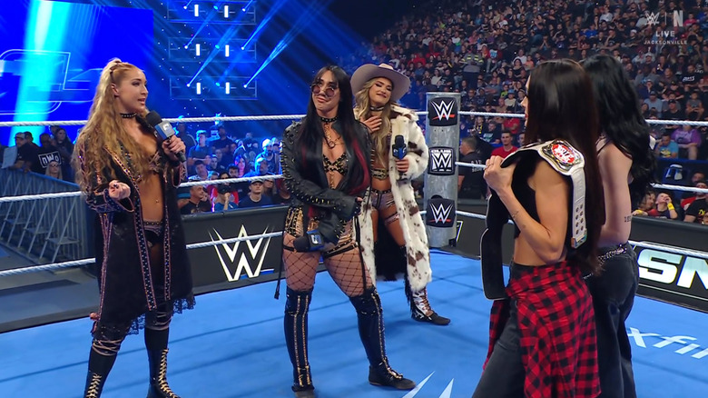 Fatal Influence confronting Paige and Brie in the ring