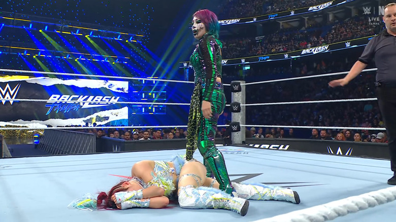 Asuka standing over SKY