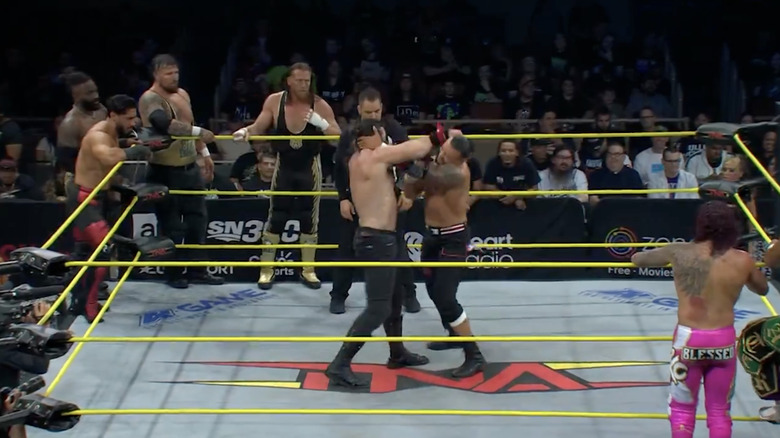 Elijah and Santana locking up in the ring