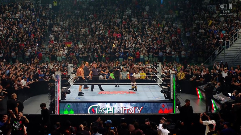 Lesnar and Femi staring down one another in the ring