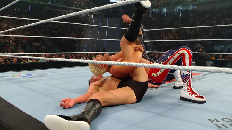 Rhodes pinning GUNTHER with GUNTHER's foot under the bottom rope