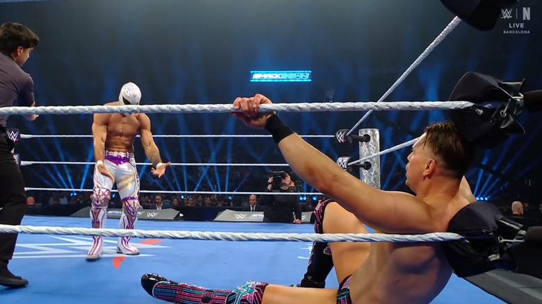 Axiom standing over The Miz in the ring