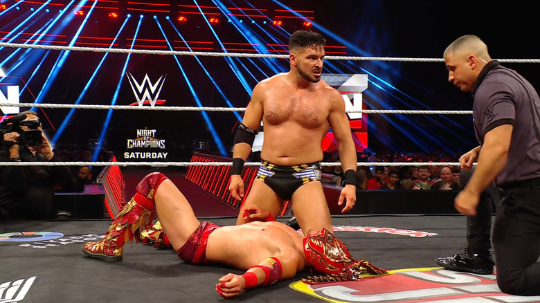 Page kneeling over Lee in the ring