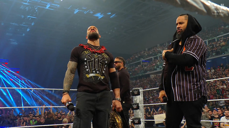 Reigns and The Usos standing inside the ring