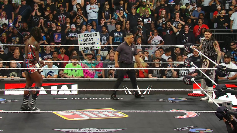 Femi in the ring and Dominik on the ring apron