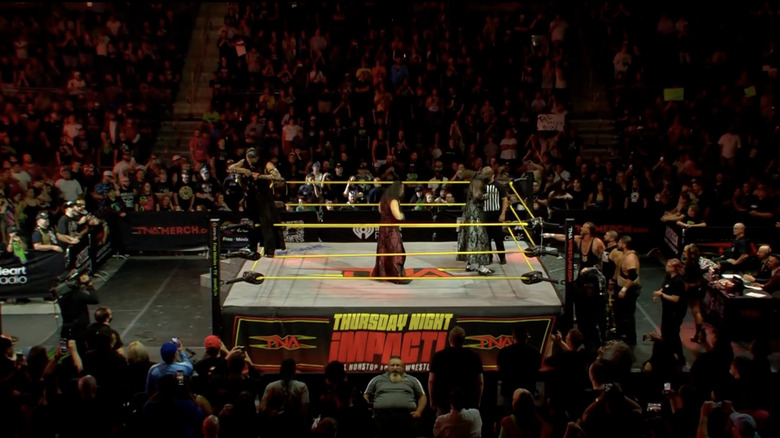 All six men inside and outside the ring yelling at each other
