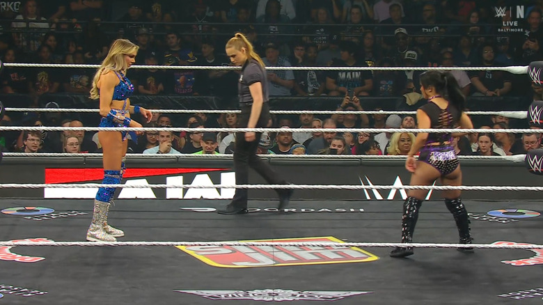 Flair and Perez staring down one another in the ring