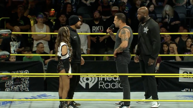 Alisha and Eddie talking to JDC and Moose in the ring