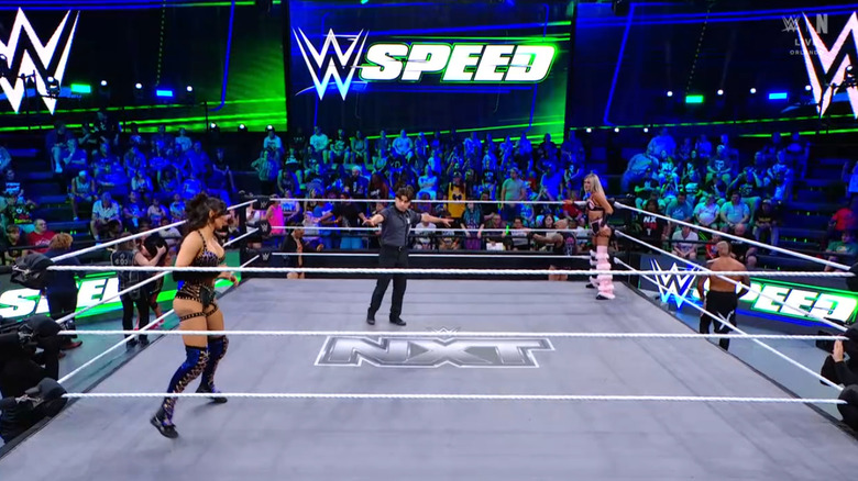 Grace and Dame staring down one another in the ring