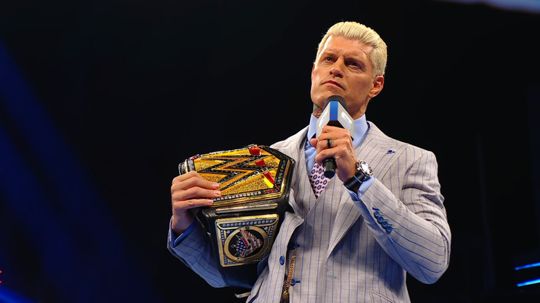 Rhodes in the ring with a microphone in hand