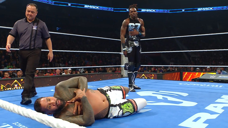 Evans standing over Jey in the ring