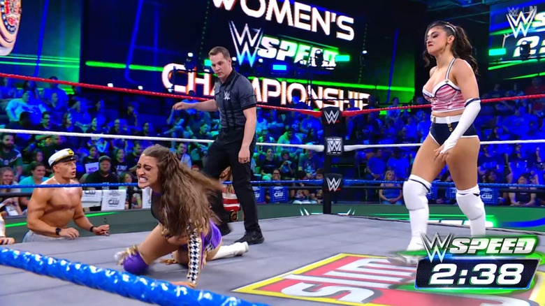Grace standing over Sinclair inside the ring