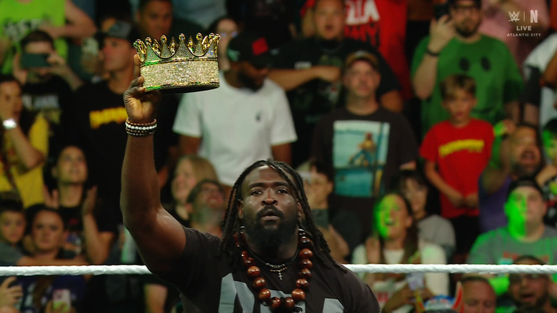 Femi holding up his King of the Ring crown