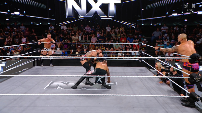 All four men in and around in the ring