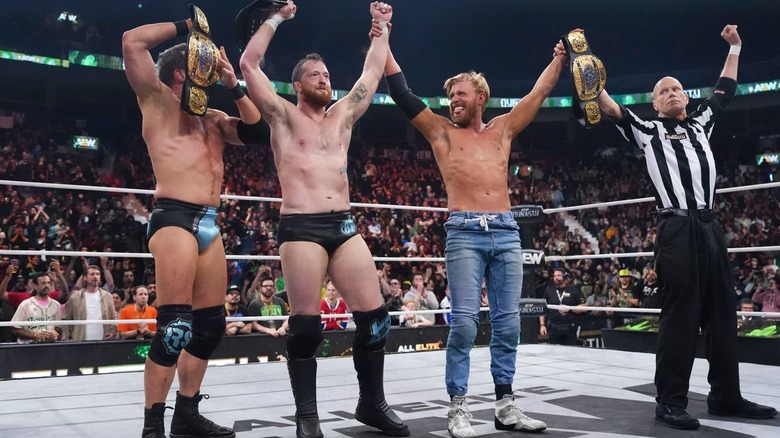The Conglomeration holding up the Trios titles