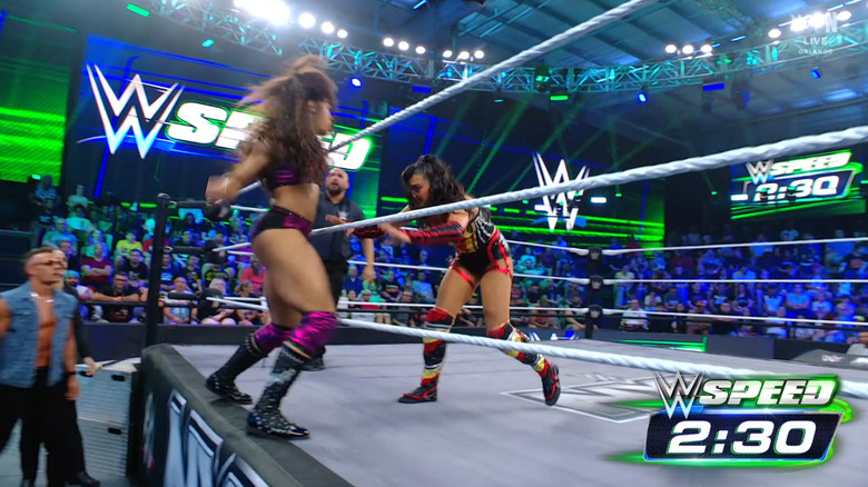 Diggs and Grace brawling around the ring apron