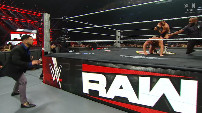 Gable with an Ankle Lock cinched in on Rusev as Page watches from the outside