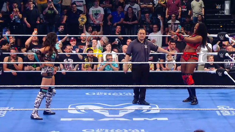 Both women in the ring staring each other down
