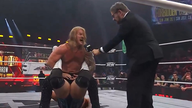 Chris Jericho locks in the Walls of Jericho while talking to Tony Schiavone