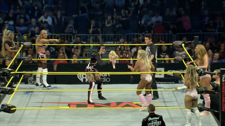 Rosemary with the doll as everyone else is in and around the ring