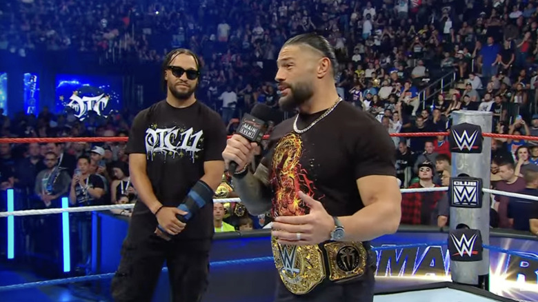Reigns speaking in the ring with Brunson standing behind him