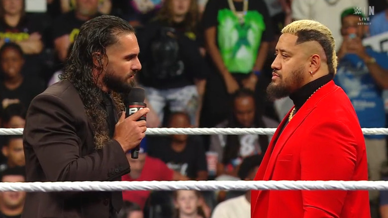 Rollins and Sikoa staring down one another in the ring