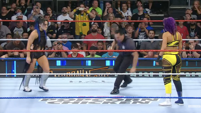 Valkyria and Bayley staring down in the ring