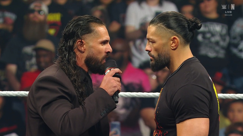 Rollins and Reigns staring down one another in the ring