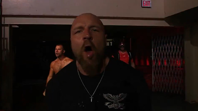 Jon Moxley enters with the Death Riders