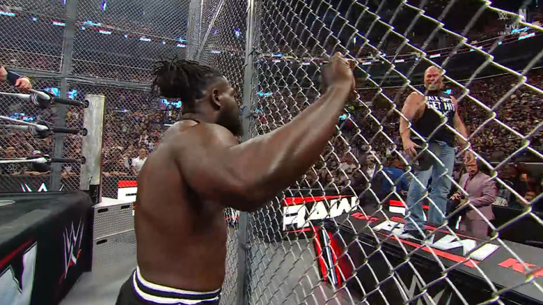 Femi in the ring and Lesnar outside the cage