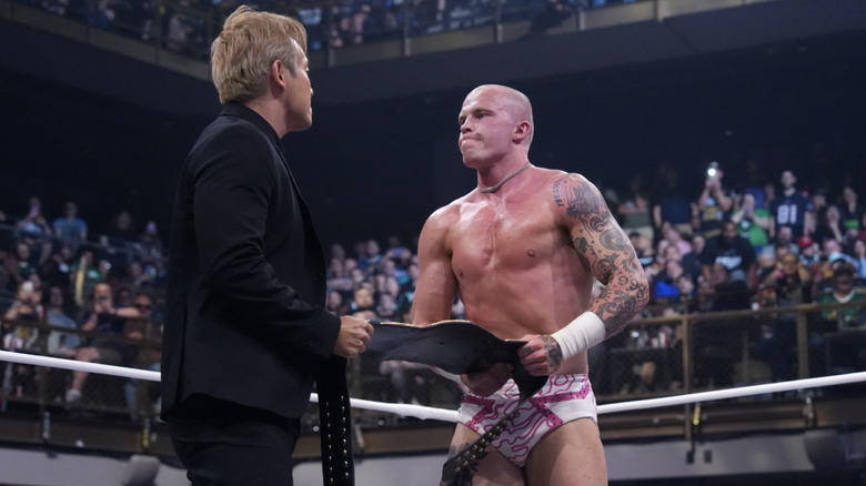 Okada and Fletcher playing Tug of War with Fletcher's International Championship belt