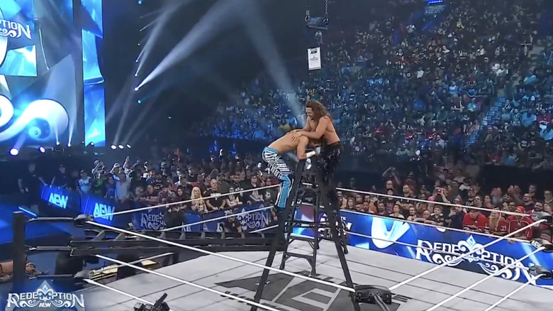 Perry and Wayne on top of a ladder in the middle of the ring