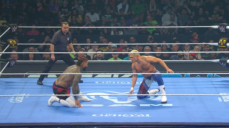 Jey and Rhodes staring down one another in the ring