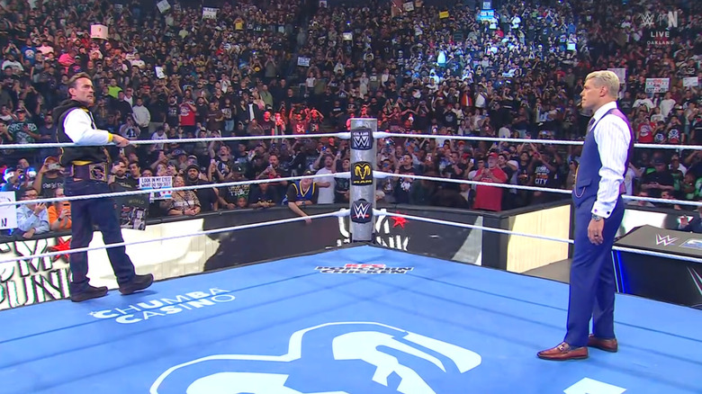 Punk and Rhodes staring down one another
