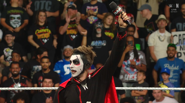 Danhausen holding up the microphone in the ring