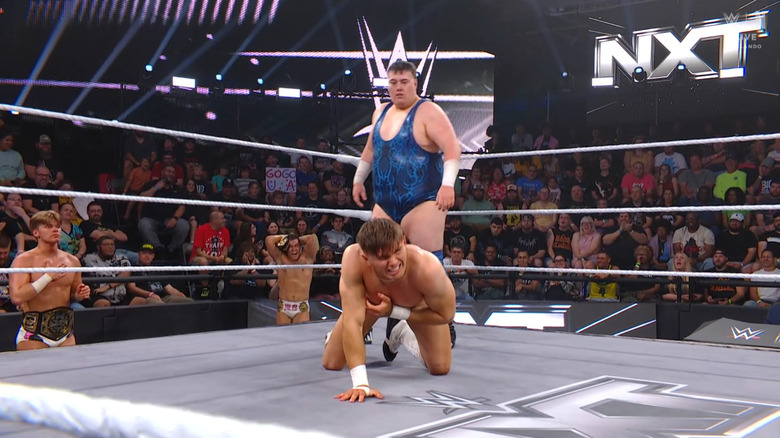 Rook standing behind Drake in the ring