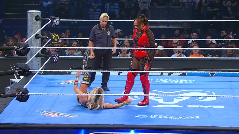 Jax standing over Flair inside the ring