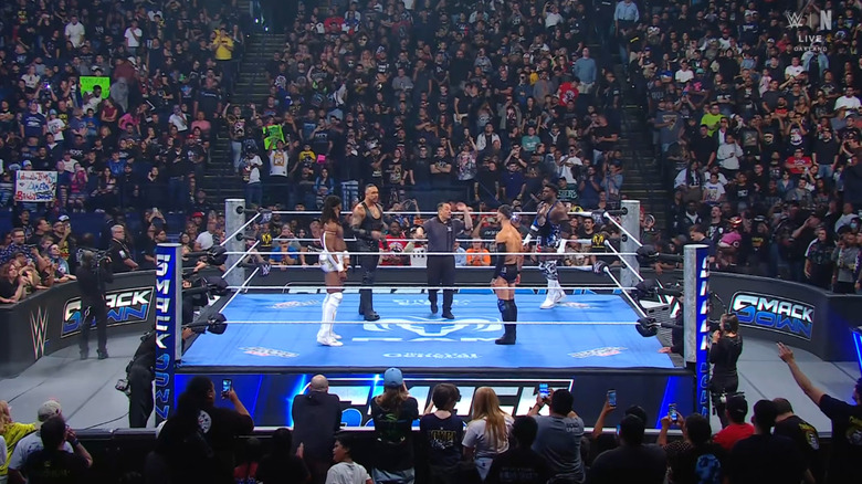 All four men staring down one another in the ring