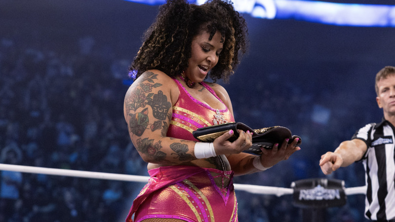 Nightingale looking down at her AEW Women's World Championship
