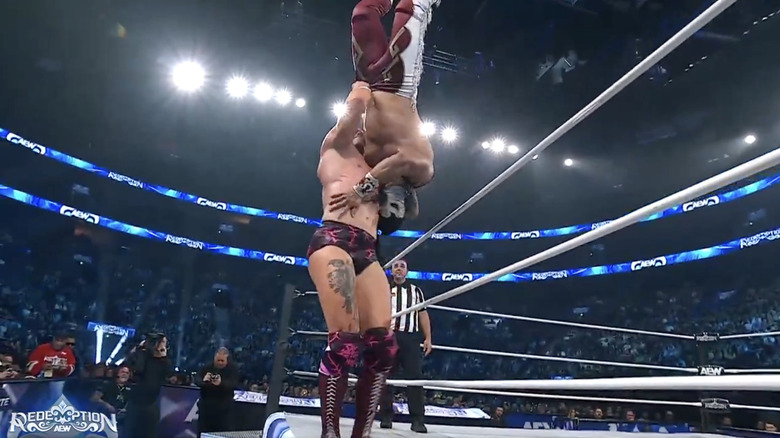Fletcher setting up for a brainbuster on Bandido on the ring apron