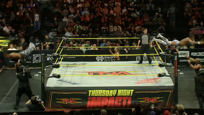 Sosa and Slater flying out of the ring to take out Eddie and Alexander