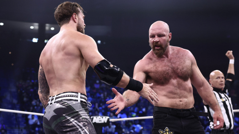 Ospreay and Moxley shaking hands with one another in the ring