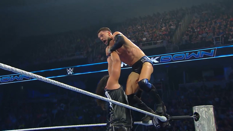 Talla Tonga looks to chokeslam Finn Balor