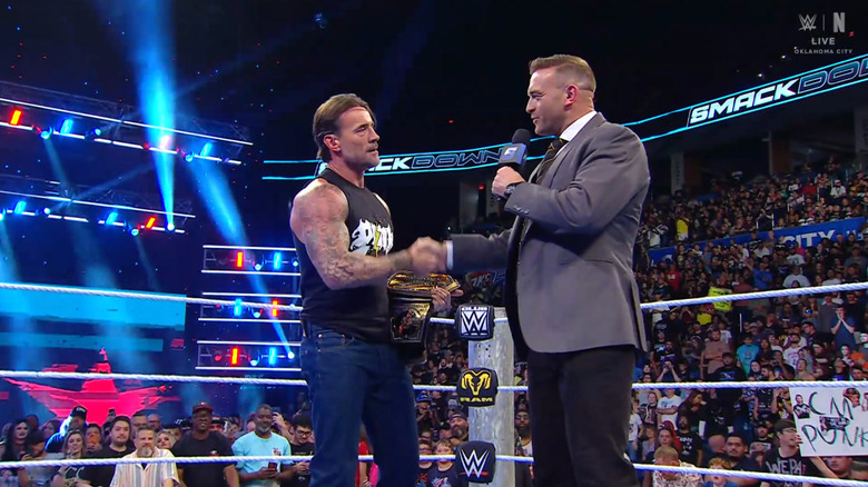 Punk shaking Aldis' hand