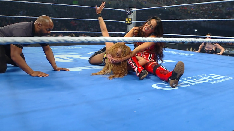 Brie wearing down Reid with a crossface