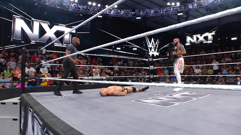 Vance with the chair in hand as Spears is down in the ring