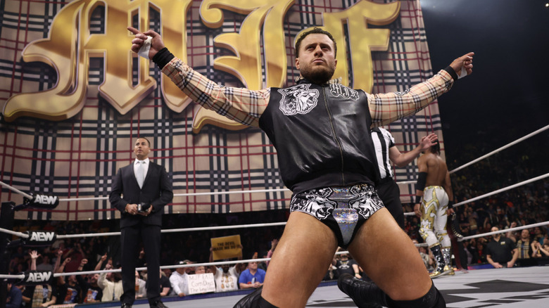 MJF kneeling in front of his banner