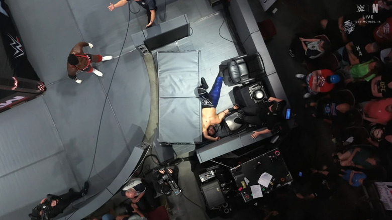 Keys standing over Fatu having just sent him crashing through the barricade